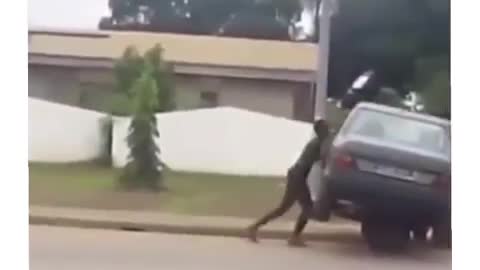 Pushing a dead car on a wheelbarrow