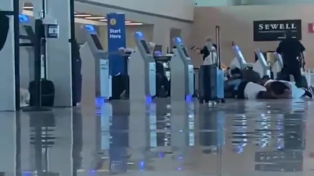 Footage of the suspect shooting a gun in the air inside Dallas Love Field