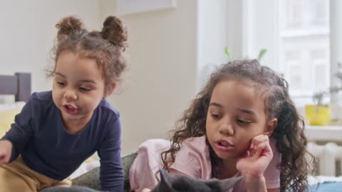 Two kids playing in bed