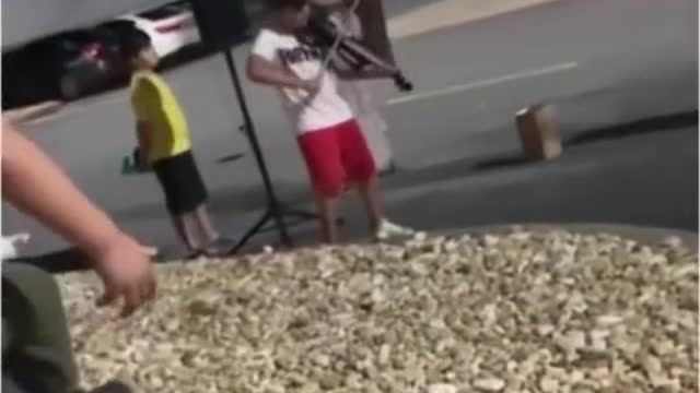 A child playing piano in the street