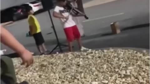 A child playing piano in the street