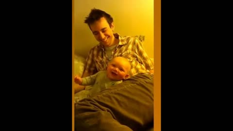 Baby laughing with dad