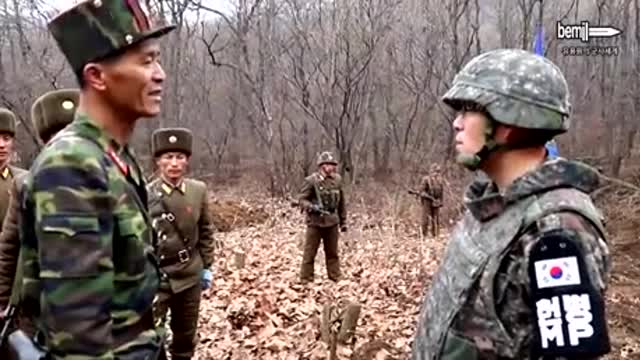 North & South Korean Soldiers Shaking Hands at the Border