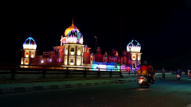 A Time Lapse Video View Of A Mosque With Colorful Lights.