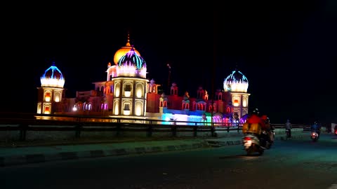 A Time Lapse Video View Of A Mosque With Colorful Lights.