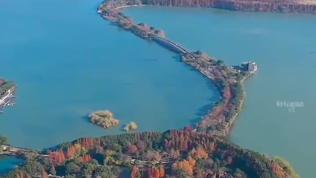 A small boat floats on the calm lake