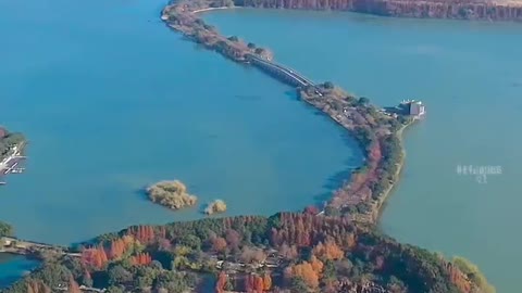 A small boat floats on the calm lake