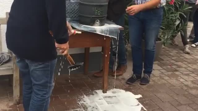 Three men can't tap beer keg