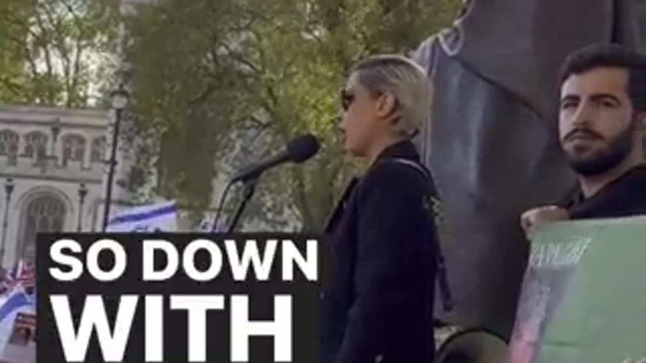 Iranian woman speaks at a rally to release Israeli hostages.