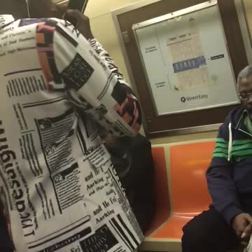 Guy suit newspaper dancing subway earphones