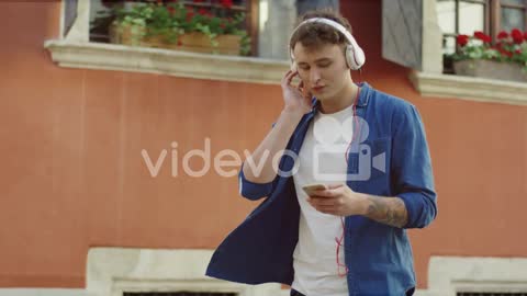 Stylish Guy Listeling To Music And Walking In The Street