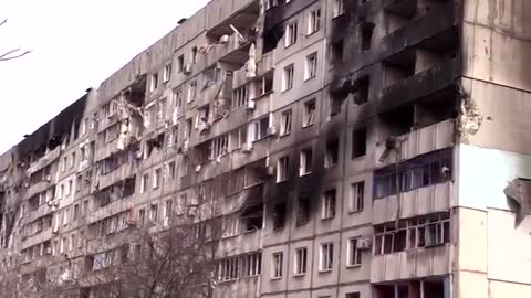 Civilians dig graves in the street and hide in basements as Mariupol hit by Russian shells