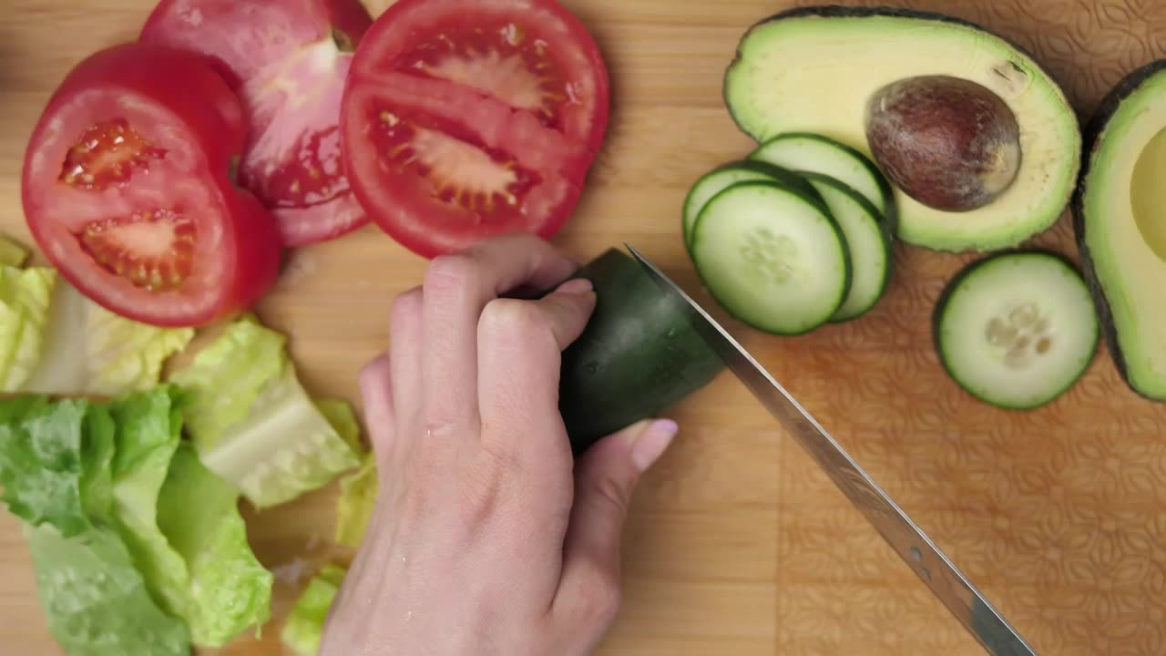 Top view of a woman slicing vegetables