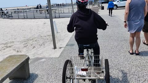 Spencer riding his tricycle at Jones beach air show VID_20230521_125221