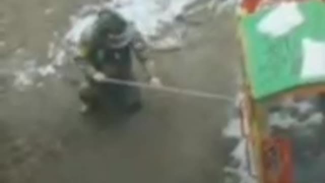 Ukrainian soldier filmed by resident laying a bottle of incendiary explosive on a kid’s playground