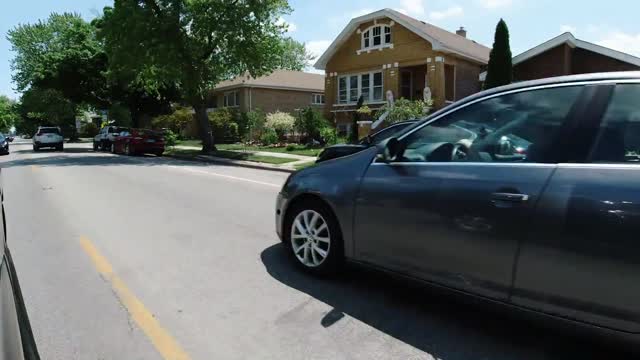 man tails car in front of him