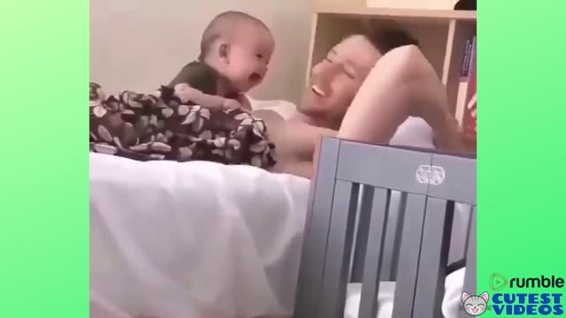 Baby laughing on his father's lap