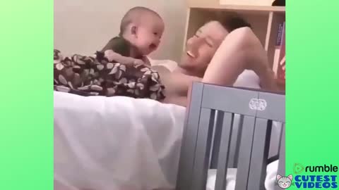 Baby laughing on his father's lap