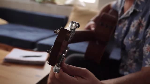 Man tuning a guitar