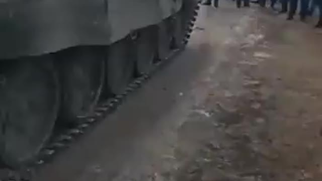 Unarmed civilians and Ukrainian police barring the advance of a Russian armored column into Ukraine.