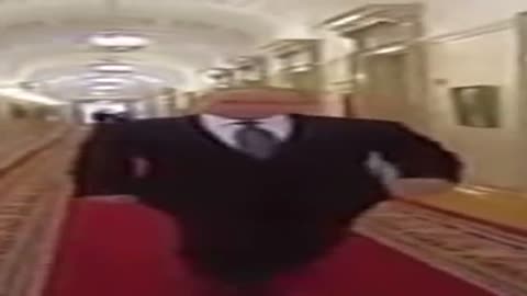 Wide Putin walking but he is always in frame