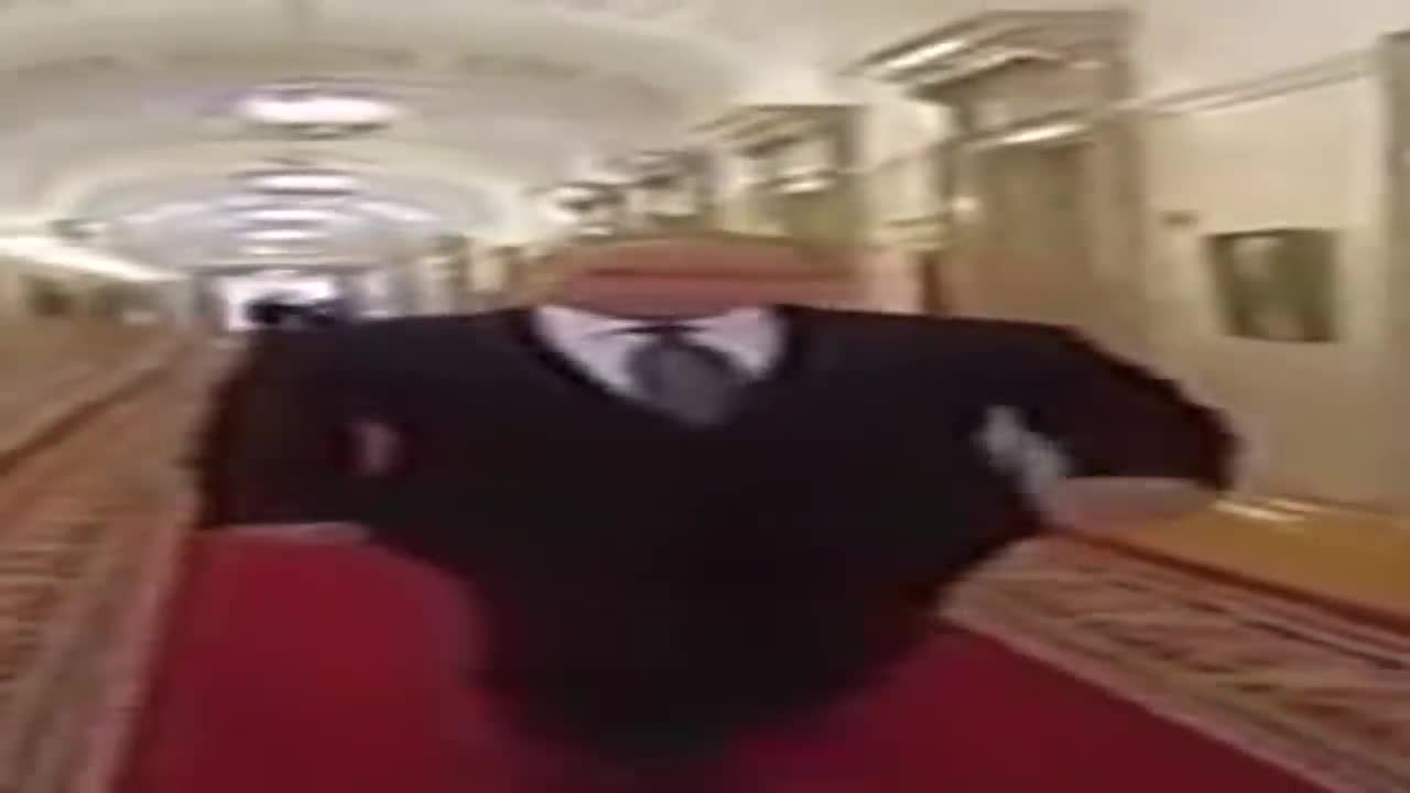 Wide Putin walking but he is always in frame