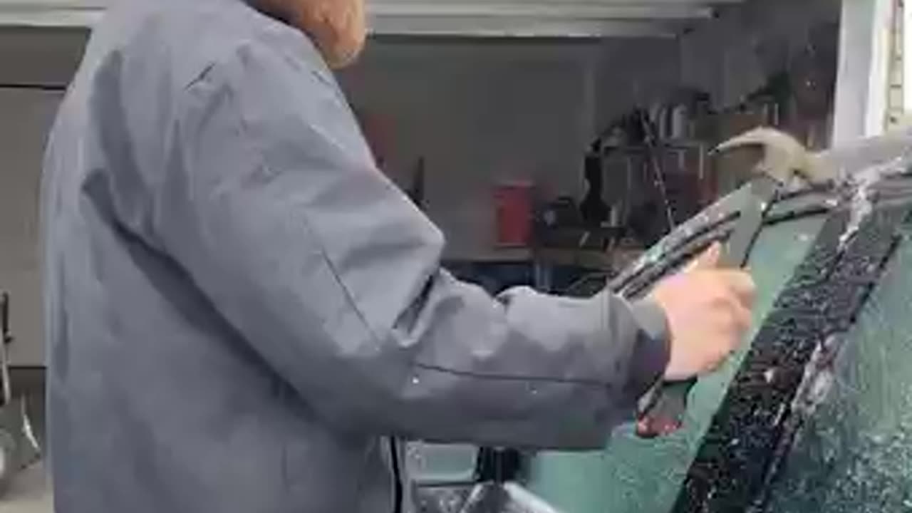 Using a hammer to open frozen car door