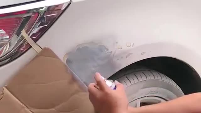 The mechanic repaired the broken paint on the car