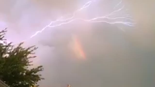 Crazy lightning show after storm and rainbow