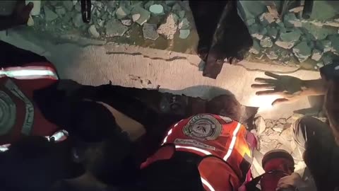 Emergency workers attempt to rescue Palestinians trapped under rubble from Israel bombing in Gaza