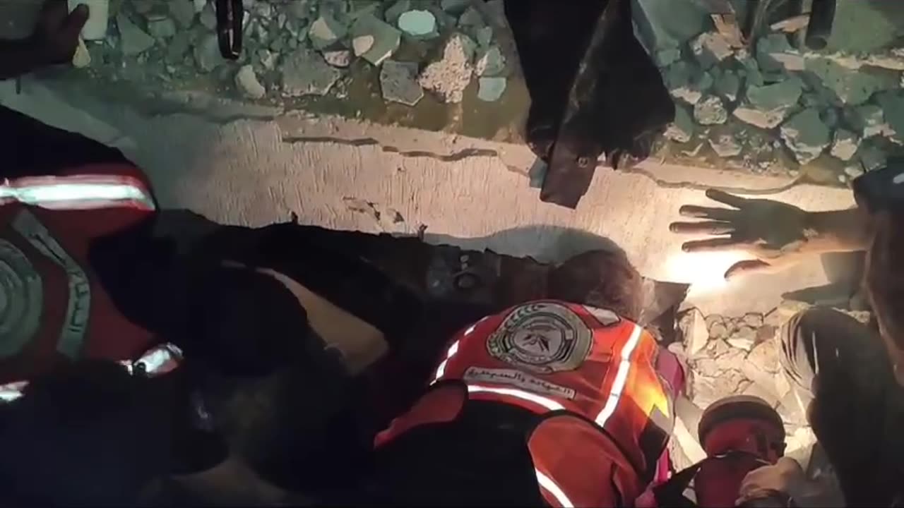 Emergency workers attempt to rescue Palestinians trapped under rubble from Israel bombing in Gaza