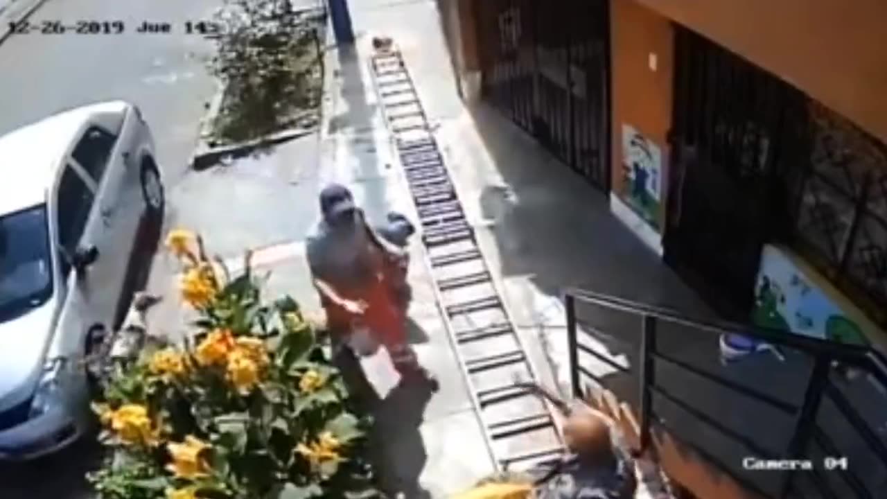 Man Shakes Ladder Vigorously Because The Worker Is Blocking His Path; Guy Falls To Sidewalk In Pain