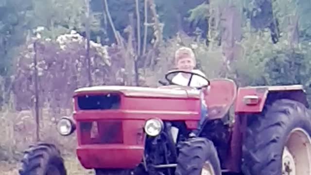 Kid riding tractor