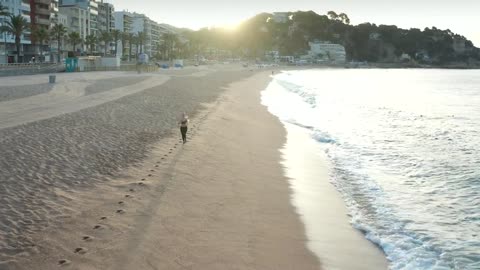 Woman running on the seashore, aerial shot
