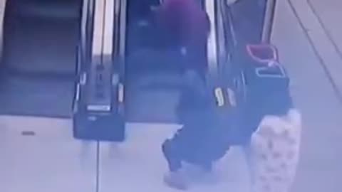 Mother Falls On Escalator w Child - Child Rides Up - But She Struggles To Stand Up.mp4