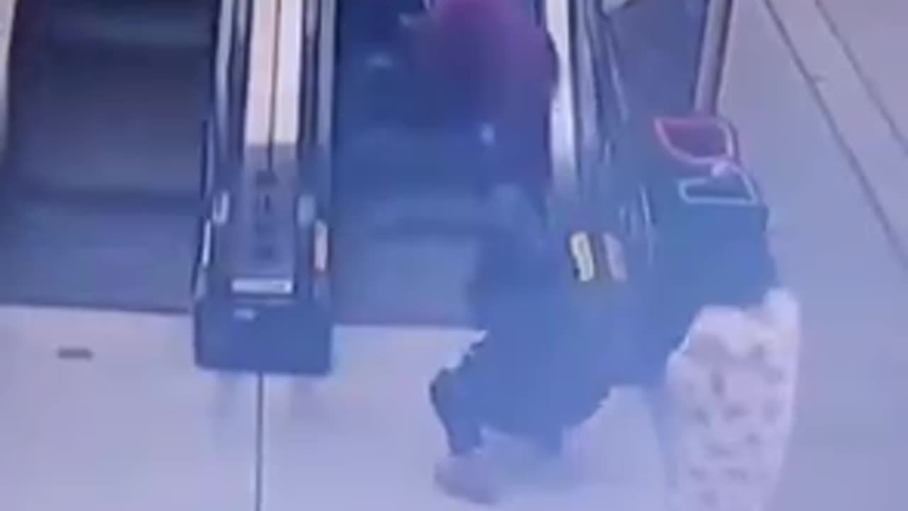 Mother Falls On Escalator w Child - Child Rides Up - But She Struggles To Stand Up.mp4