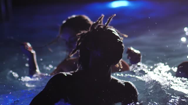 Boys and girls dancing in a pool