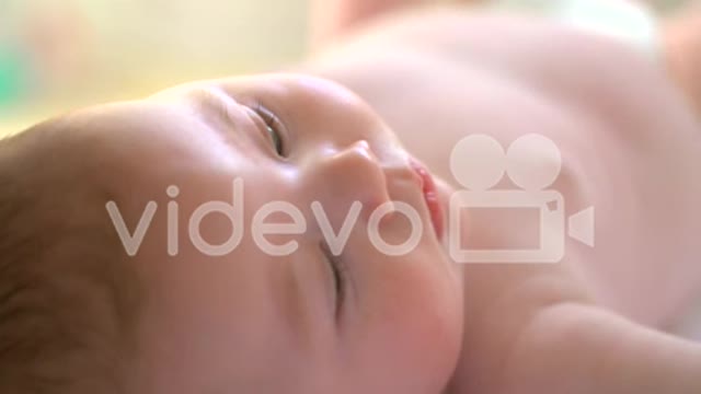 Baby lying on back in sunlight