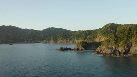 Aerial tour around a coastline on a sunny day