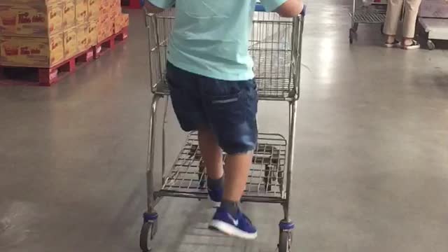 The boy shows off his amazing driving in the supermarket