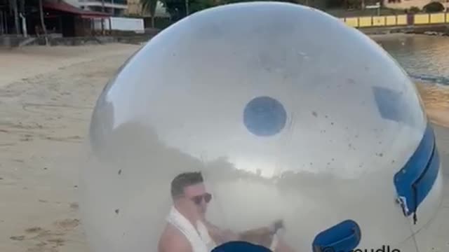 Man Enjoys a Trip to the Beach in Isolation Bubble