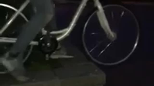 Kid on white bike rides off wall and faceplants