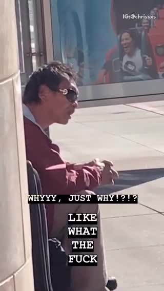Guy flicks his tongue up and down waiting for bus stop