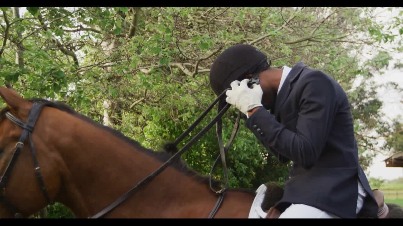 African American man riding his Dressage horse