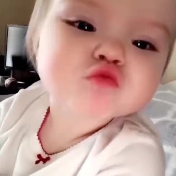 toddler saying hi and giving kisses on camera