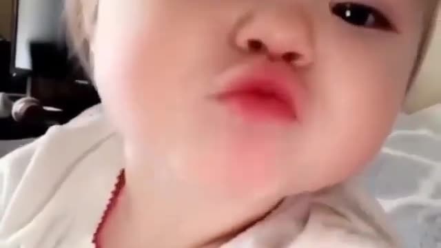 toddler saying hi and giving kisses on camera