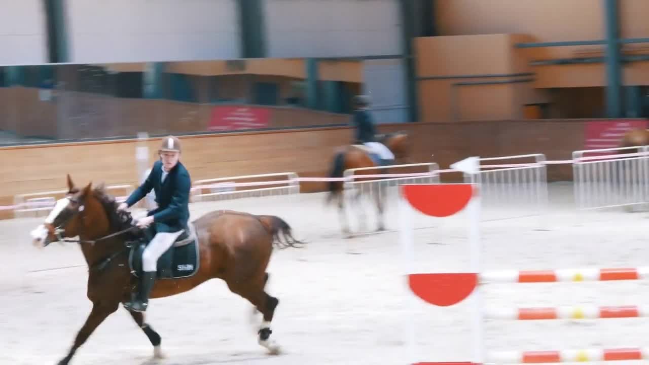 Equestrian championship - Young man racing on a horse over obstacle