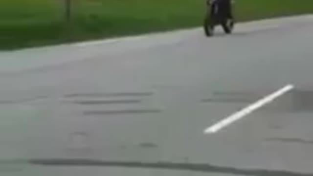 Blue motorcycle wheelie faceplant