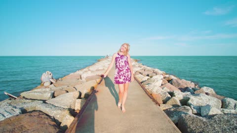 view of a cute girl walking by the ocean