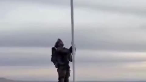 The Israeli flag is raised over Jabal Al-Sheikh in Syria